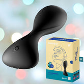A black Satisfyer Trendsetter Anal Vibrator from the brand Satisfyer sits next to its beige and blue packaging, beautifully illustrated and labeled. The soft, colorful bokeh lights in the background add an enchanting touch to this customizable vibration experience.